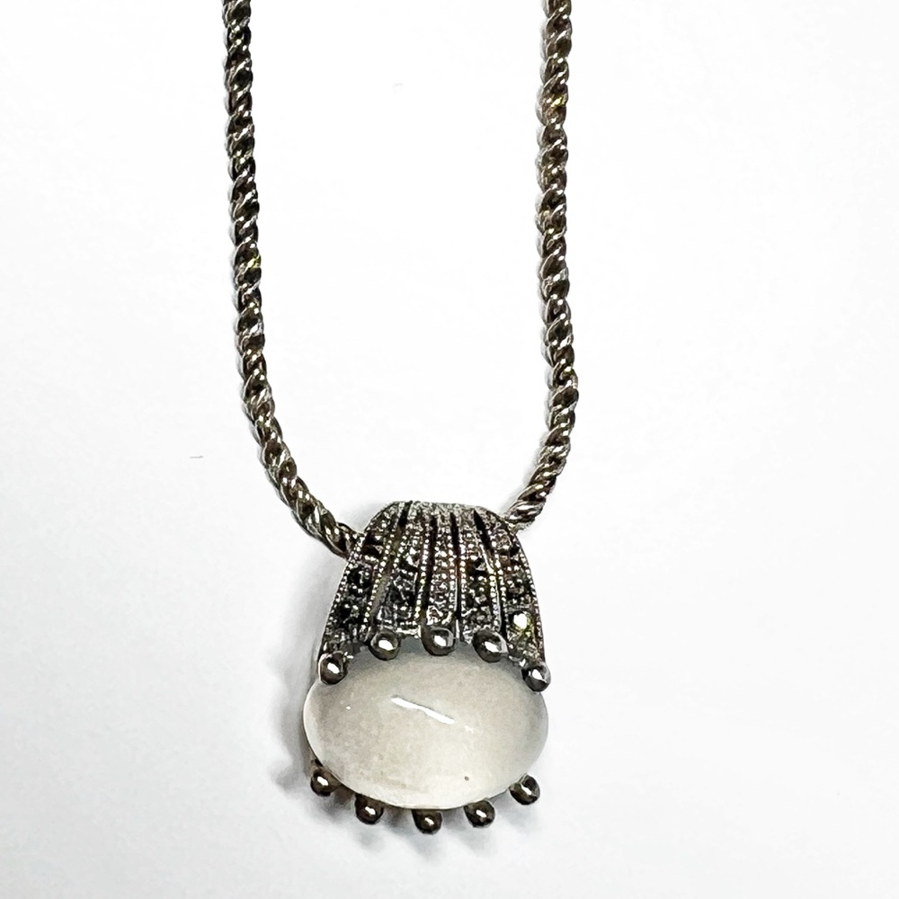 Chic contemporary Silver pendant on silver tone chain, with visual accents